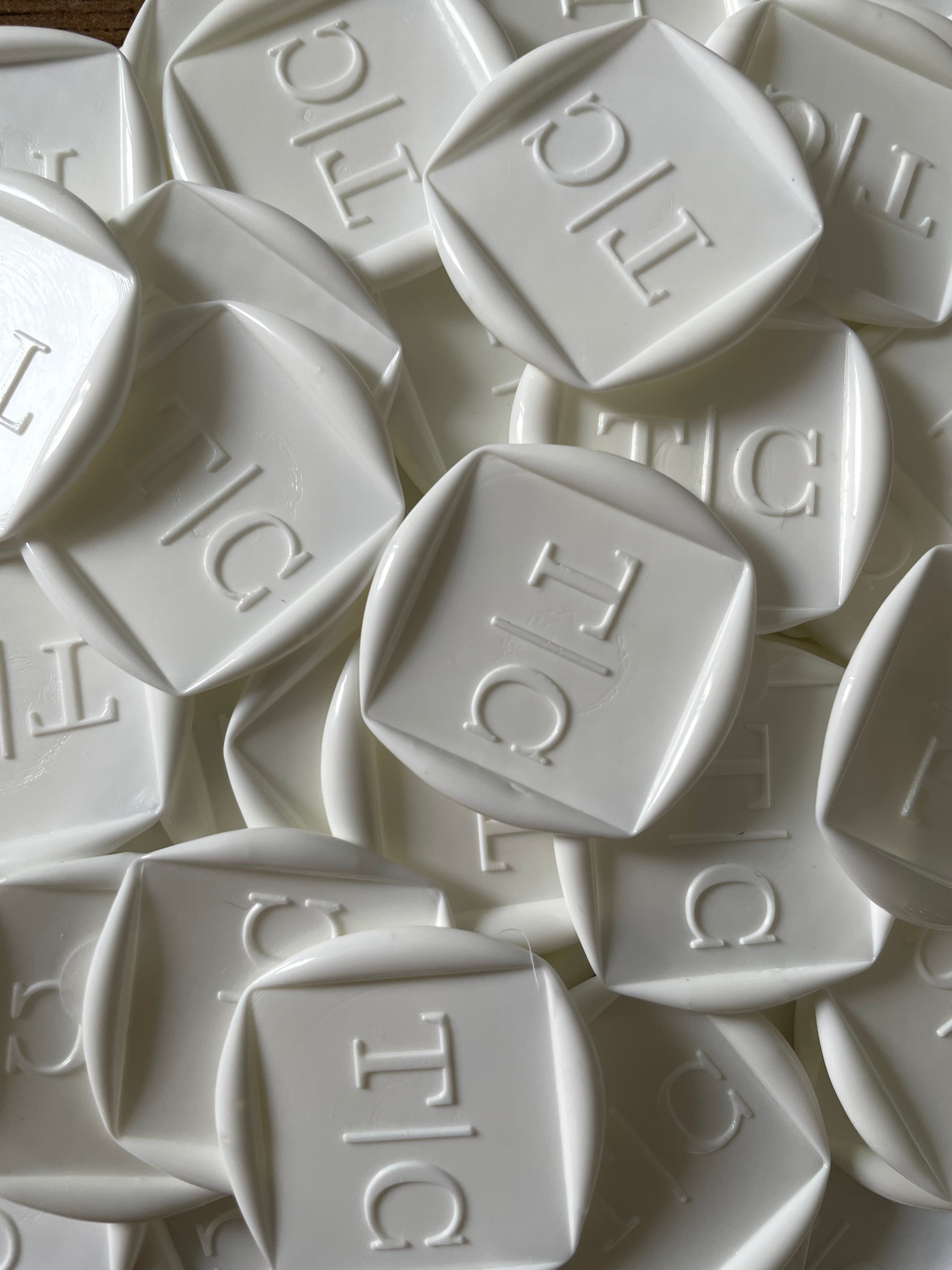 White custom wax seal with embossed initials for wedding envelope sealing