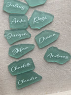 Sea glass place cards with handwritten names for wedding table settings