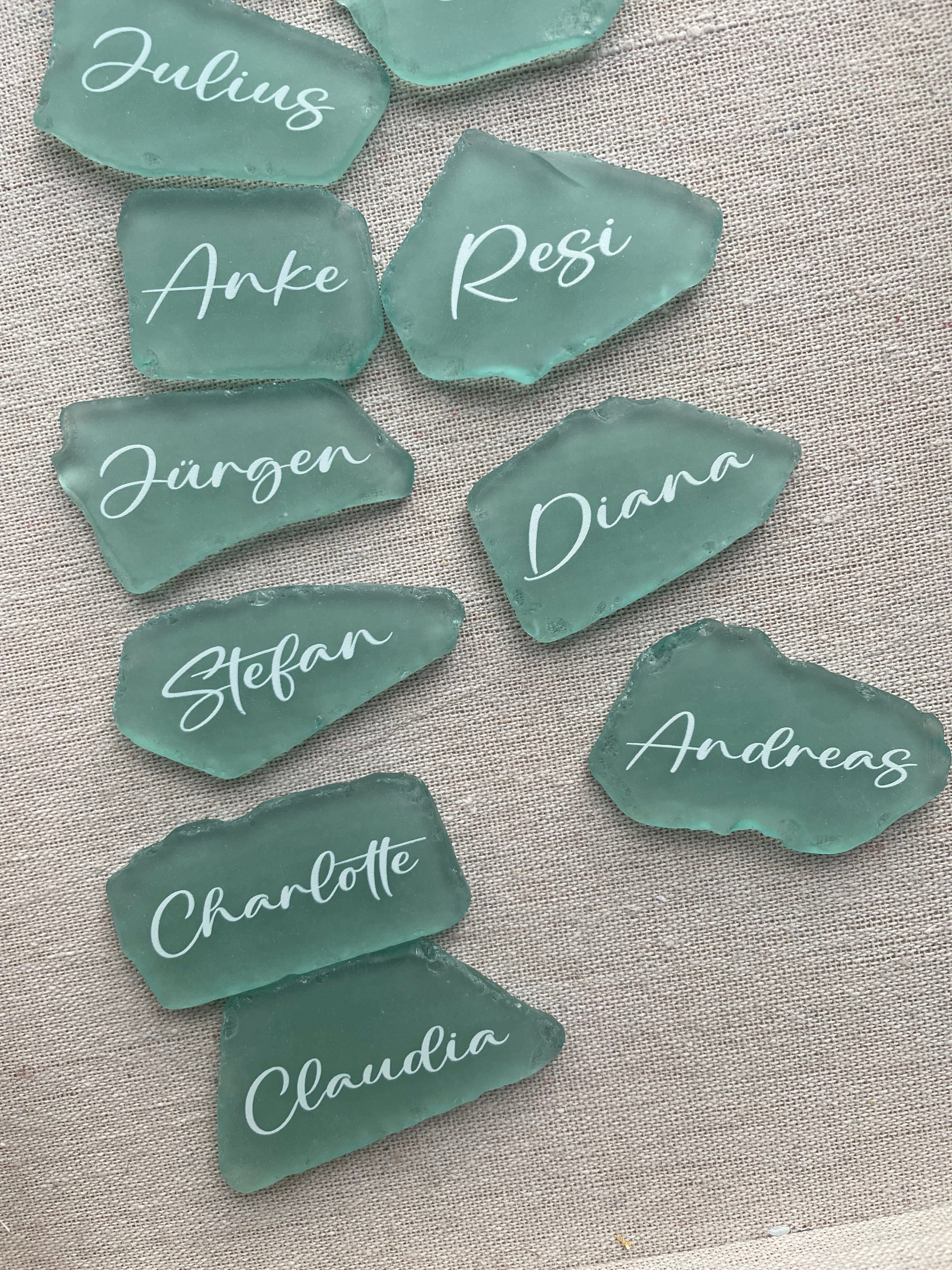 Sea glass place cards with handwritten names for wedding table settings