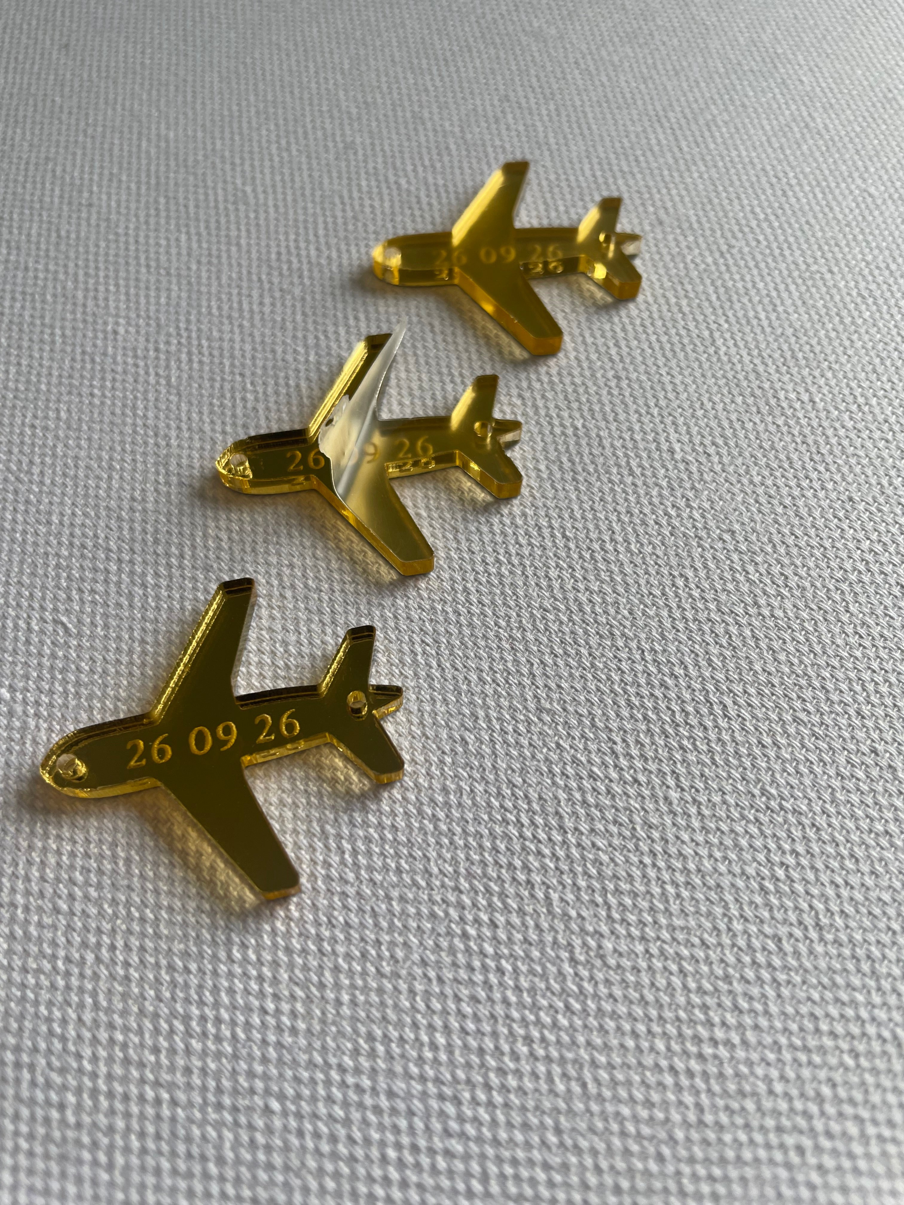 White and gold airplane charms for wedding decoration and invitations
