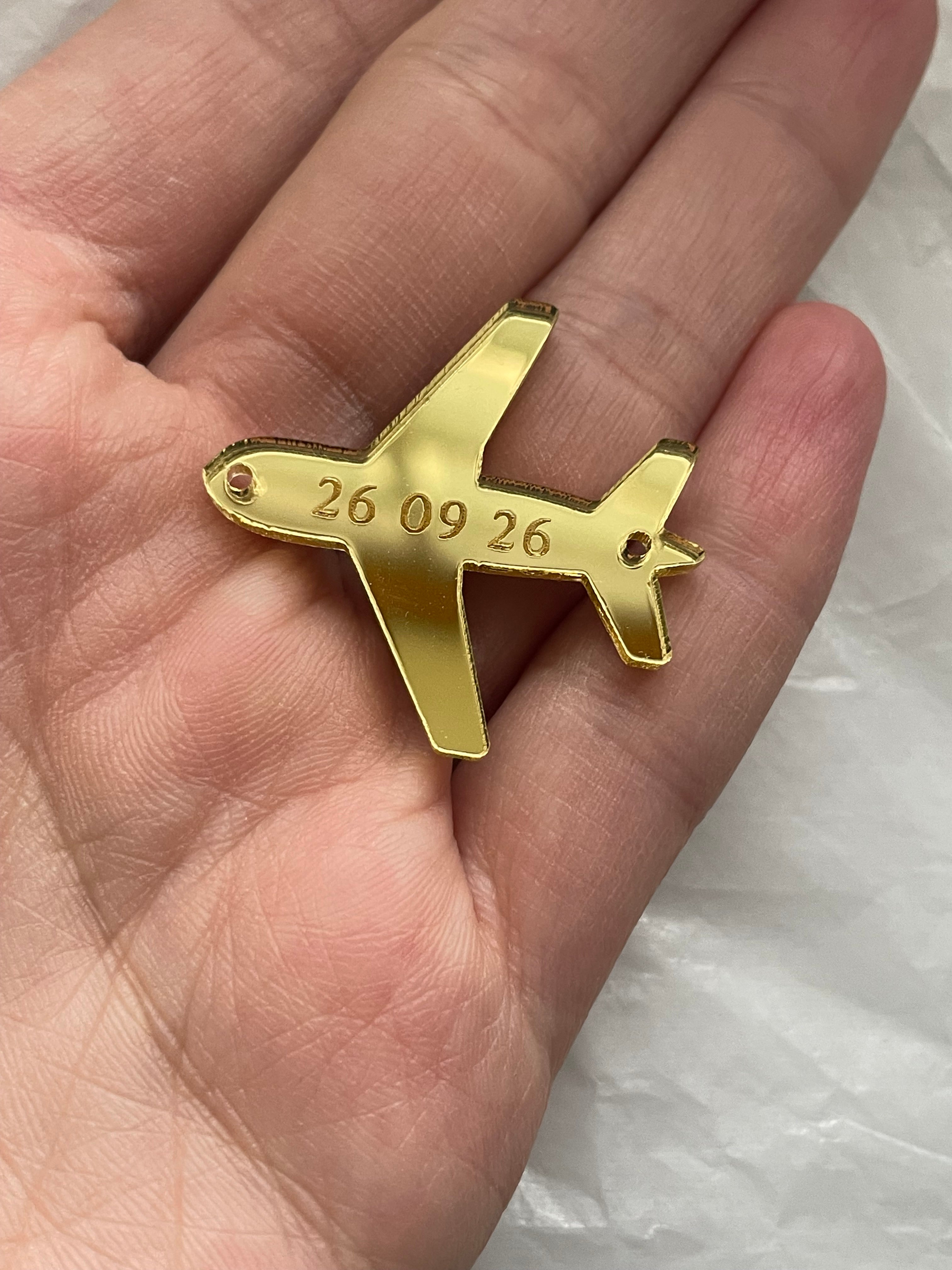 Gold airplane charms with engraved date for wedding keepsakes