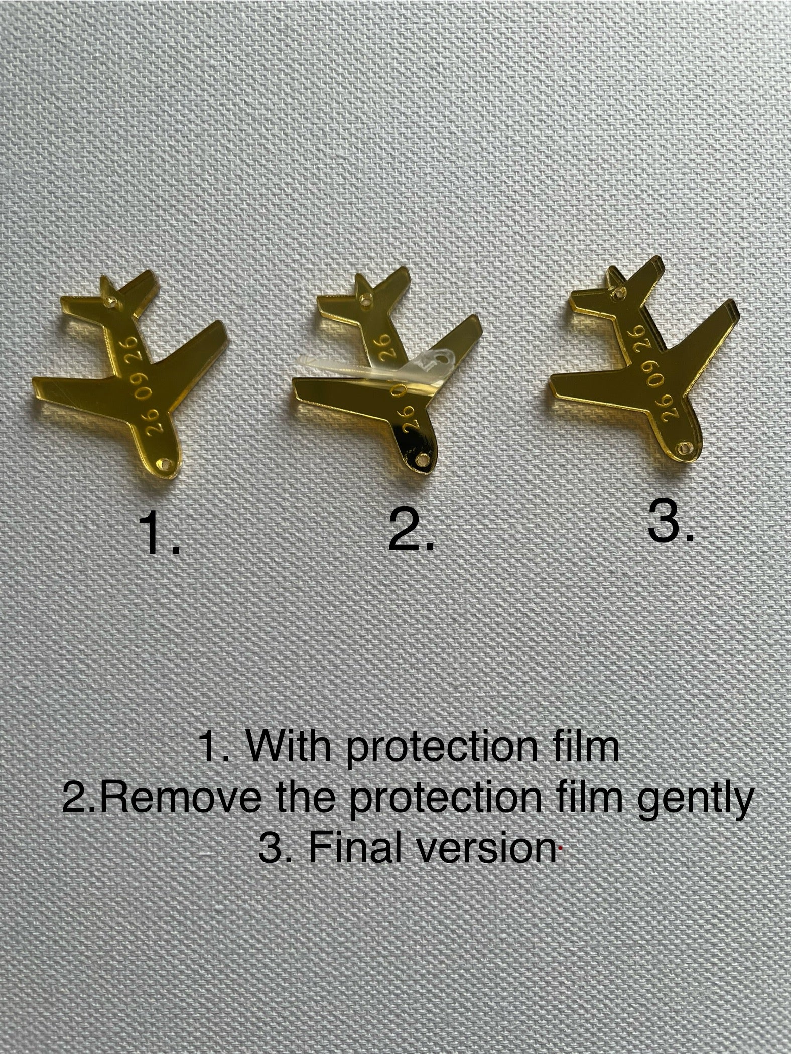 Set of gold airplane charms with engraved date for wedding favors