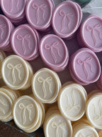 Pink and ivory wax seals with bow design for wedding invitations