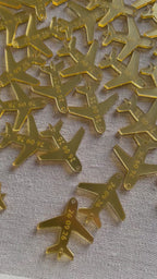 Assorted gold airplane charms for wedding favors